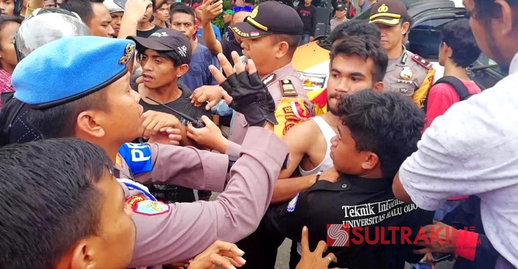 Aksi saling dorong antara massa aksi dan aparat kepolisian di depan kantor Dinas Tenaga Kerja dan Transmigrasi Sultra, Selasa (1/5/2018). (Foto: Wayan Sukanta/SULTRAKINI.COM)