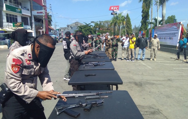 Enam anggota Polres Baubau saat memasang senapan dan pistol yang telah dibongkar. (Foto: Zarmin/SULTRAKINI.COM).