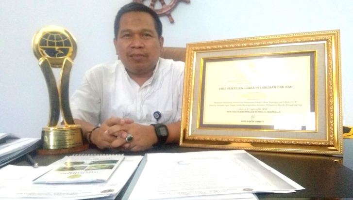 Kepala Kantor UPP Kelas I Baubau memperlihatkan plakat dan piagam penghargaan dari Kemenhub, Jumat(21/9/2018). (Foto: Zarmin/SULTRAKINI.COM)