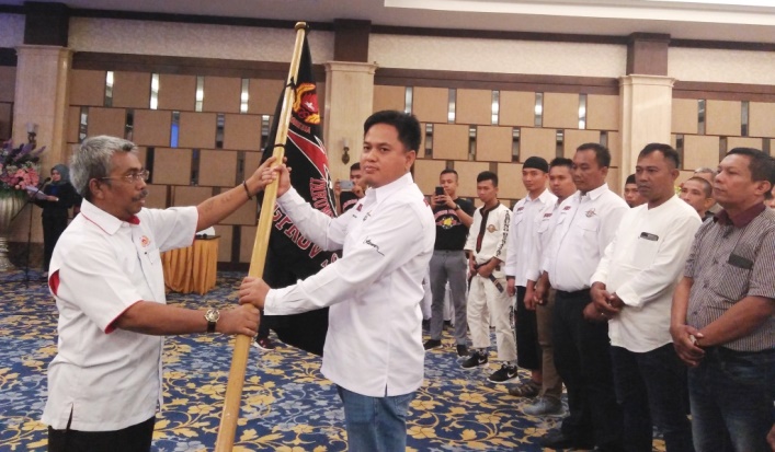 Sekum KONI Sultra, Erickson Ludji menyerahkan bendera pataka kepada Ketua Pengprov Kodrat Sultra, Rusmin Abdul Gani, Selasa (26/3/2019). (Foto: Muh Yusuf/SULTRAKINI.COM)