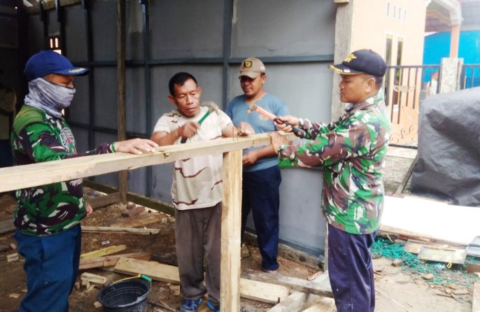 Personil TNI-AL saat melakukan pengerjaan bedah rumah di Desa Sama Jaya Kabupaten Konawe, Senin (29/4/2019). (Foto Hasrul Tamrin/SULTRAKINI.COM).