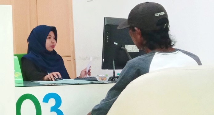 La Hadini mengurus administrasi pencairan jaminan pensiun di BPJS Ketenagakerjaan cabang Kendari. (Foto: Hasrul Tamrin/SULTRAKINI.COM)